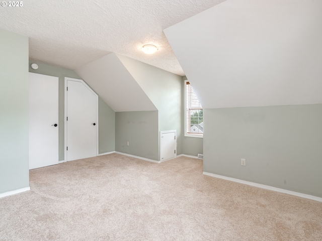 2487 Southslope Way W, Linn, OR 97068 - bonus room with light colored carpet, vaulted ceiling, a textured ceiling, and baseboards