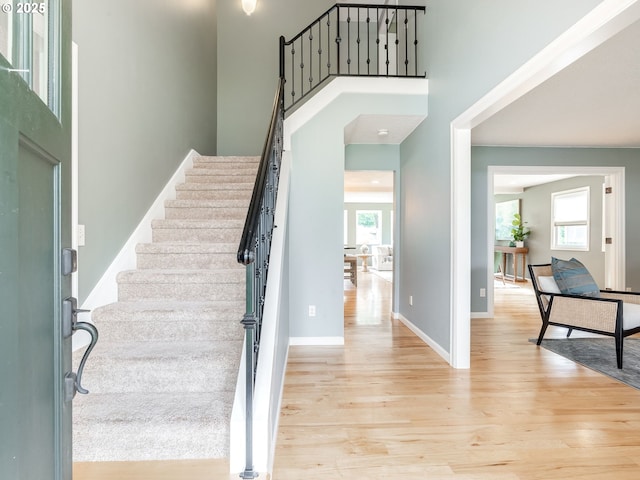 2487 Southslope Way W, Linn, OR 97068 - foyer featuring plenty of natural light, light wood-type flooring, stairs, baseboards, and a high ceiling