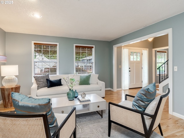 2487 Southslope Way W, Linn, OR 97068 - living room with baseboards, light wood-style floors, and stairway