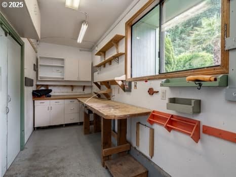 2487 Southslope Way W, Linn, OR 97068 - kitchen featuring open shelves, concrete flooring, white cabinets, and light countertops