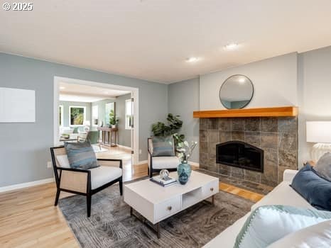 2487 Southslope Way W, Linn, OR 97068 - living area with wood finished floors, a fireplace, and baseboards