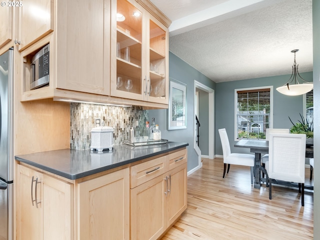 2487 Southslope Way W, Linn, OR 97068 - kitchen featuring appliances with stainless steel finishes, light brown cabinetry, tasteful backsplash, dark countertops, and a textured ceiling