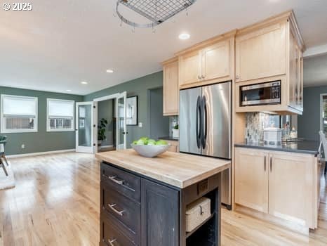 2487 Southslope Way W, Linn, OR 97068 - kitchen with stainless steel appliances, light brown cabinetry, recessed lighting, light wood-style floors, and open floor plan
