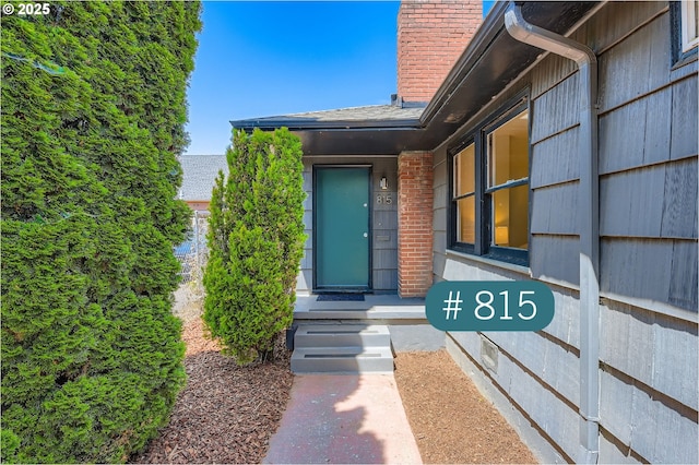 815/821 NE Holman St, Portland, OR 97211 - doorway to property featuring a chimney and brick siding