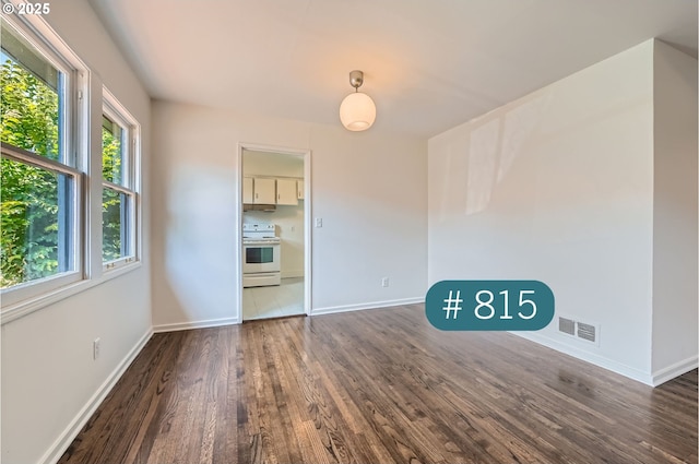 815/821 NE Holman St, Portland, OR 97211 - unfurnished room with dark wood finished floors and baseboards