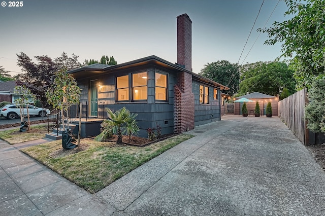 815/821 NE Holman St, Portland, OR 97211 - view of front of home with driveway and a chimney