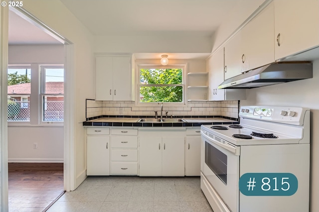 815/821 NE Holman St, Portland, OR 97211 - kitchen featuring white electric range, under cabinet range hood, tile counters, and white cabinetry