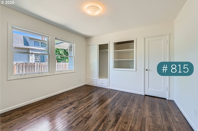 815/821 NE Holman St, Portland, OR 97211 - unfurnished bedroom with dark wood-style flooring and a closet