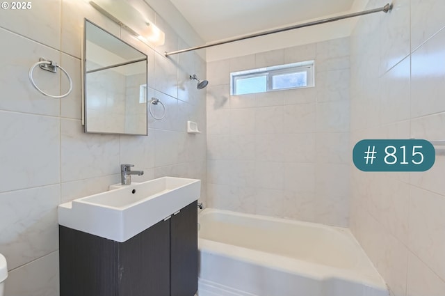 815/821 NE Holman St, Portland, OR 97211 - bathroom featuring tile walls, shower / washtub combination, and vanity