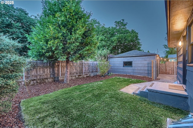 815/821 NE Holman St, Portland, OR 97211 - fenced backyard with an outbuilding and a patio area