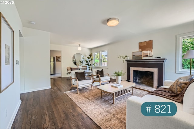 815/821 NE Holman St, Portland, OR 97211 - living area featuring dark wood-type flooring, a fireplace with flush hearth, and healthy amount of natural light