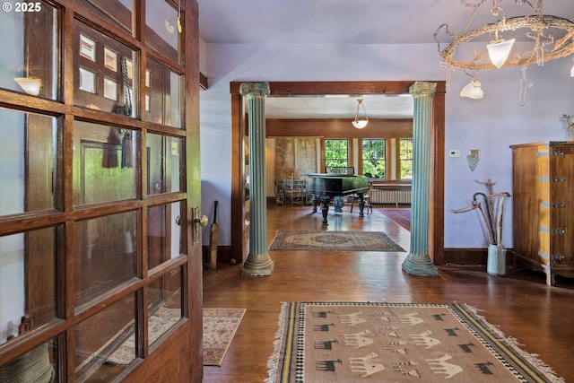 91755 Lewis And Clark Rd, Astoria, OR 97103 - corridor with ornate columns, wood finished floors, and radiator