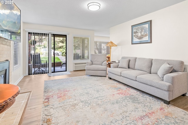 15565 SW 114th Ct Unit 23, Portland, OR 97224 - living area with wood finished floors and a brick fireplace