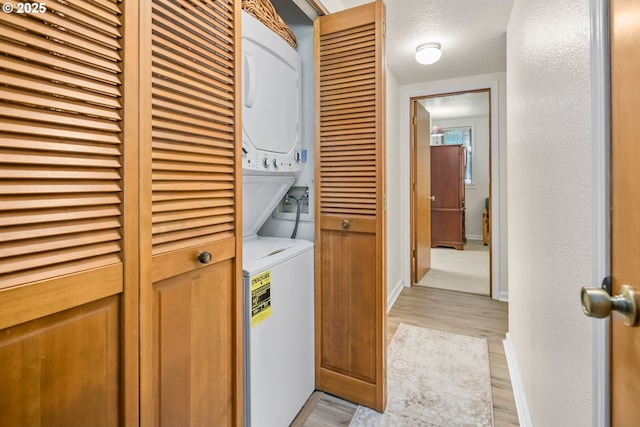 15565 SW 114th Ct Unit 23, Portland, OR 97224 - washroom with stacked washer / dryer and light wood finished floors