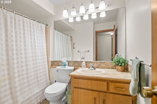 15565 SW 114th Ct Unit 23, Portland, OR 97224 - bathroom featuring vanity, decorative backsplash, and curtained shower