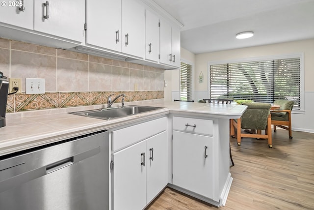 15565 SW 114th Ct Unit 23, Portland, OR 97224 - kitchen featuring dishwasher, white cabinetry, light wood-style floors, backsplash, and a peninsula