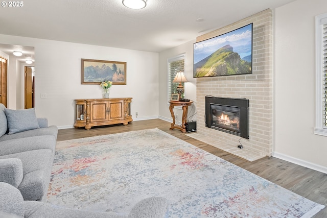 15565 SW 114th Ct Unit 23, Portland, OR 97224 - living room featuring a fireplace and wood finished floors