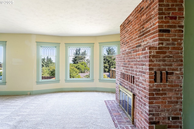 1005 Reserve St, Silverton, OR 97381 - unfurnished living room with carpet flooring, a brick fireplace, and a textured ceiling