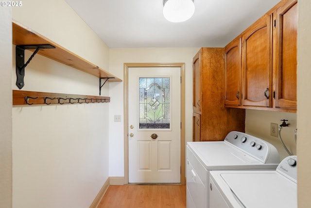 1005 Reserve St, Silverton, OR 97381 - washroom with cabinet space, light wood finished floors, and washing machine and clothes dryer