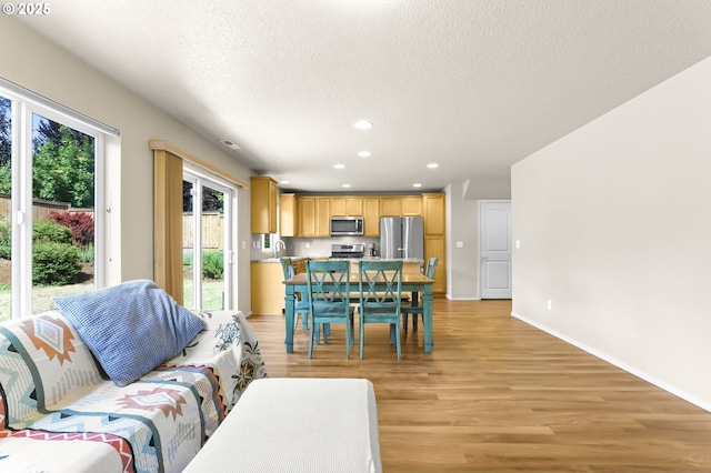 37125 Goldenrain St, Sandy, OR 97055 - living room featuring light wood-style floors, recessed lighting, and a textured ceiling