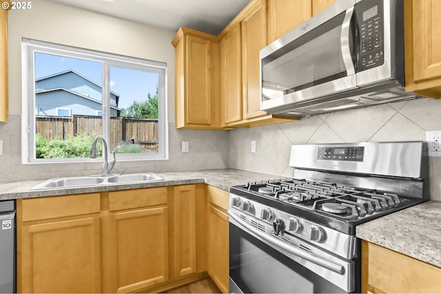 37125 Goldenrain St, Sandy, OR 97055 - kitchen featuring appliances with stainless steel finishes, decorative backsplash, and light countertops
