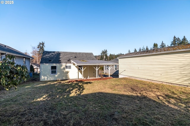 rear view of property featuring a lawn