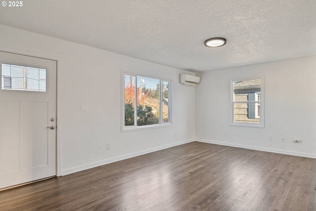 foyer featuring plenty of natural light, dark hardwood / wood-style flooring, and a wall mounted AC