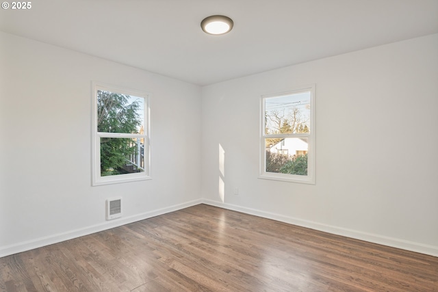 spare room with dark wood-type flooring