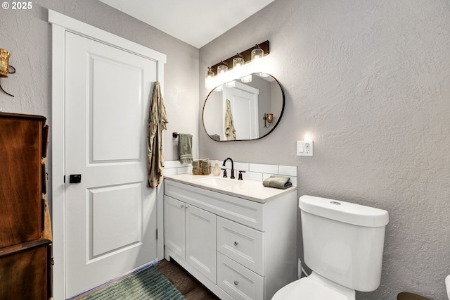 48521 E 1st St, Oakridge, OR 97463 - bathroom featuring vanity, toilet, a textured wall, and wood finished floors