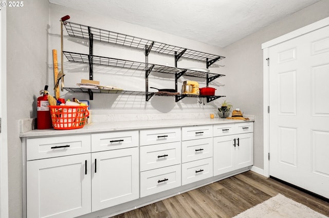 48521 E 1st St, Oakridge, OR 97463 - bar with light wood-style flooring, baseboards, and a textured ceiling