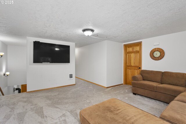 living area with carpet floors, baseboards, and a textured ceiling
