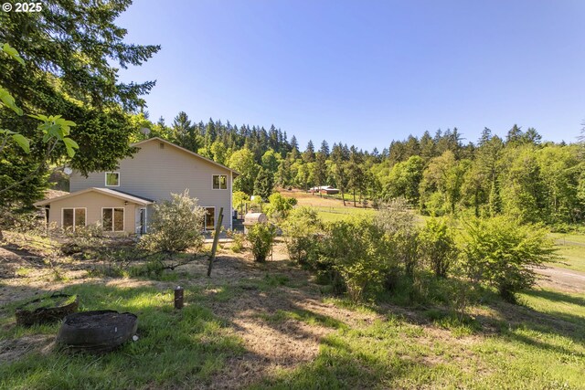 view of yard with a view of trees