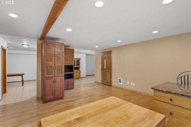 9275 SE Terrace View Ct, Amity, OR 97101 - kitchen featuring light wood finished floors, recessed lighting, brown cabinets, and dark stone countertops