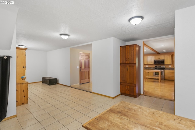 9275 SE Terrace View Ct, Amity, OR 97101 - empty room featuring light tile patterned floors and a textured ceiling