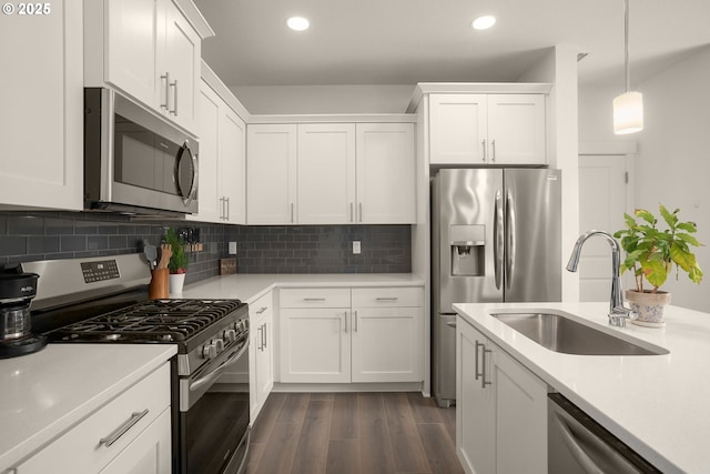 833 S 25th Ter, Cornelius, OR 97113 - kitchen with appliances with stainless steel finishes, dark wood-style flooring, white cabinets, light countertops, and recessed lighting