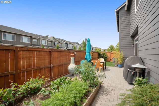 833 S 25th Ter, Cornelius, OR 97113 - fenced backyard with area for grilling, a residential view, a patio area, and a vegetable garden