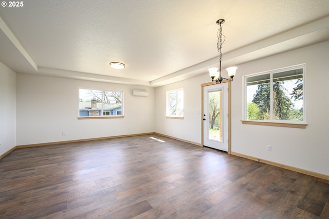 440 NW Gutbrod St, Sheridan, OR 97378 - spare room with a wall mounted air conditioner, a notable chandelier, baseboards, and dark wood finished floors