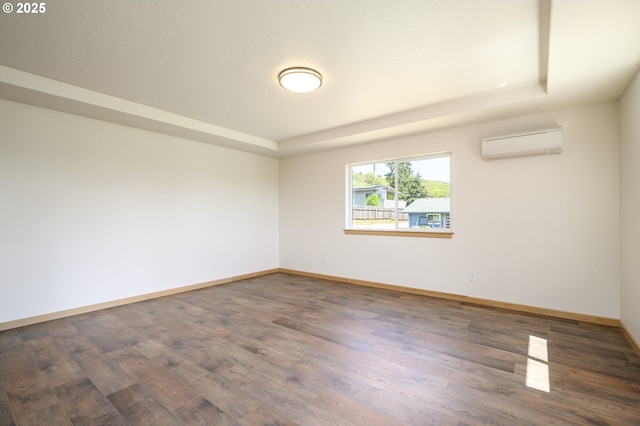 440 NW Gutbrod St, Sheridan, OR 97378 - spare room with baseboards, wood finished floors, a raised ceiling, and a wall mounted AC