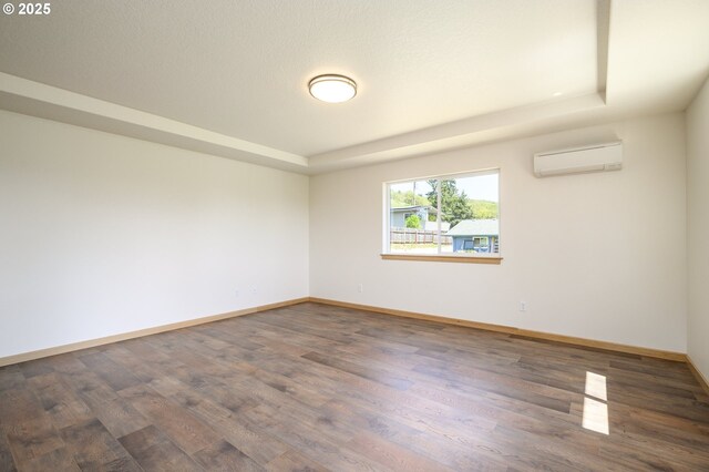 440 NW Gutbrod St, Sheridan, OR 97378 - empty room with a wall mounted AC, wood finished floors, and a raised ceiling
