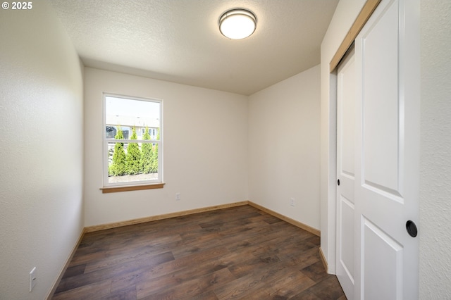 440 NW Gutbrod St, Sheridan, OR 97378 - unfurnished bedroom with dark wood-type flooring, baseboards, and a closet