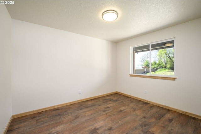 440 NW Gutbrod St, Sheridan, OR 97378 - spare room with baseboards, a textured ceiling, and dark wood-style flooring