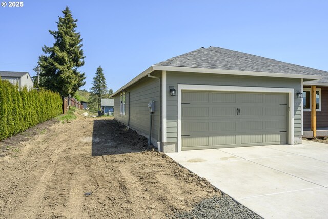 440 NW Gutbrod St, Sheridan, OR 97378 - view of property exterior with concrete driveway, an attached garage, and roof with shingles