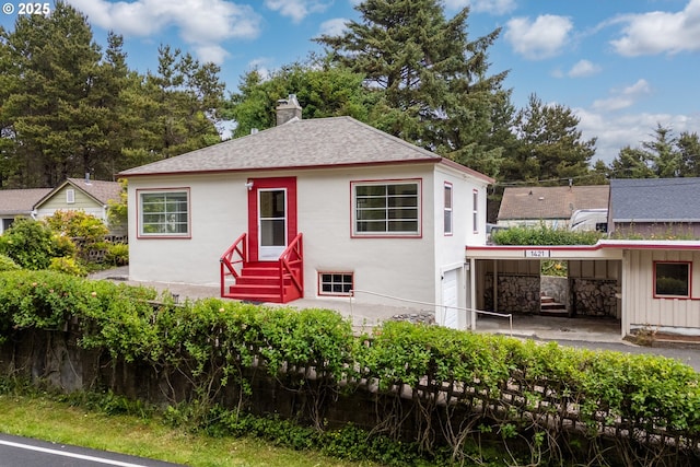 1421 SW Fleet Ave, Lincoln City, OR 97367 - bungalow-style home with entry steps, roof with shingles, a chimney, and stucco siding