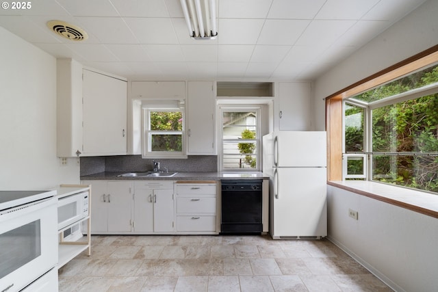 1421 SW Fleet Ave, Lincoln City, OR 97367 - kitchen featuring white appliances, plenty of natural light, backsplash, and white cabinets