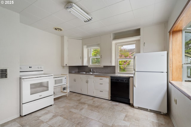 1421 SW Fleet Ave, Lincoln City, OR 97367 - kitchen with white appliances, a sink, decorative backsplash, and white cabinetry