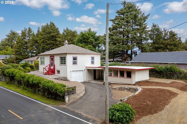 1421 SW Fleet Ave, Lincoln City, OR 97367 - view of front facade featuring a garage, driveway, and stucco siding