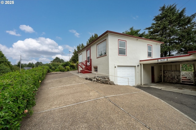 1421 SW Fleet Ave, Lincoln City, OR 97367 - view of side of property with stucco siding, driveway, and an attached garage