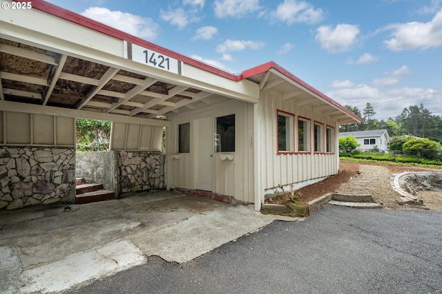 1421 SW Fleet Ave, Lincoln City, OR 97367 - view of side of home with board and batten siding and a carport