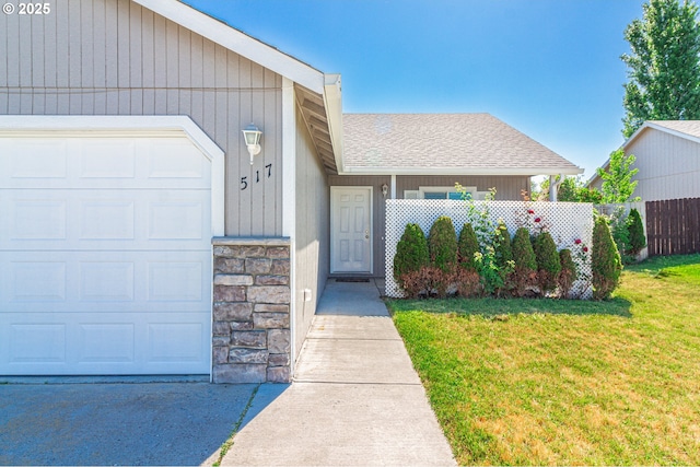 517 Anthony Dr, Boardman, OR 97818 - view of exterior entry with roof with shingles, an attached garage, and stone siding
