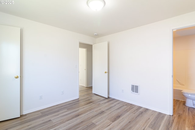 517 Anthony Dr, Boardman, OR 97818 - unfurnished bedroom with light wood-type flooring, baseboards, and connected bathroom